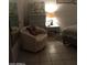 Bedroom with a comfortable chair, dresser, and tiled floor at 9627 W North Ln # B, Peoria, AZ 85345