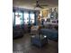 Bright living room with tiled floors, comfy seating, and large window at 9627 W North Ln # B, Peoria, AZ 85345