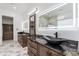 Elegant bathroom with dark wood cabinets and marble flooring at 12942 S 192Nd Ave, Buckeye, AZ 85326