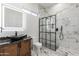 Spa-like bathroom with marble and black accents at 12942 S 192Nd Ave, Buckeye, AZ 85326