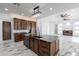 Open concept kitchen with large island and dark wood cabinetry at 12942 S 192Nd Ave, Buckeye, AZ 85326