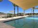 Relaxing community pool with shade structures and lounge chairs at 15788 W Mariposa Grande Ave, Surprise, AZ 85387