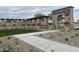 Elegant community entrance with stone pillars and landscaping at 15788 W Mariposa Grande Ave, Surprise, AZ 85387