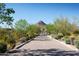 Long driveway entrance with landscaping and mountain views at 9889 E Happy Valley Rd # 5, Scottsdale, AZ 85255