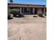 Rear view of home showcasing a covered patio and desert landscaping at 15717 W Linksview Dr, Surprise, AZ 85374