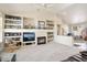 Gathering room with a fireplace, built-in shelving and a large TV at 15717 W Linksview Dr, Surprise, AZ 85374