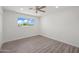 Bright bedroom with wood-look flooring and large window at 2024 N Miller Rd, Scottsdale, AZ 85257