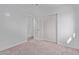Well-lit bedroom featuring carpet flooring and an open door to hallway at 17627 N 14Th Ave, Phoenix, AZ 85023