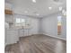 Modern kitchen with white cabinets and wood-look floors at 17627 N 14Th Ave, Phoenix, AZ 85023