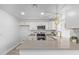 Modern kitchen with white cabinets, gold accents, and a quartz island at 17627 N 14Th Ave, Phoenix, AZ 85023