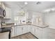 Updated kitchen with white cabinets, quartz countertops and gold accents at 17627 N 14Th Ave, Phoenix, AZ 85023