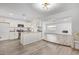Modern kitchen with white cabinets, island, and stainless steel appliances at 17627 N 14Th Ave, Phoenix, AZ 85023
