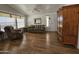 Bright living room featuring hardwood floors, comfy seating, and large windows at 650 N Hawes Rd # 4956, Mesa, AZ 85207