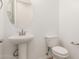 Modern bathroom with pedestal sink, toilet and updated fixtures at 16399 W Avenida Del Sol --, Surprise, AZ 85387