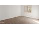Simple bedroom with carpeted floor and large window at 16399 W Avenida Del Sol --, Surprise, AZ 85387