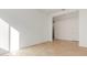 Spacious bedroom with wood-look flooring and access to hallway at 16399 W Avenida Del Sol --, Surprise, AZ 85387