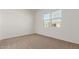 Bright bedroom featuring neutral carpeting and large windows at 16399 W Avenida Del Sol --, Surprise, AZ 85387