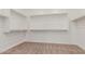 Large walk-in closet with double hanging rods and shelving at 16399 W Avenida Del Sol --, Surprise, AZ 85387