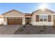 One-story home with brown garage door and desert landscaping at 16399 W Avenida Del Sol --, Surprise, AZ 85387