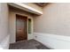 Front entry with a brown door and sidelight at 16399 W Avenida Del Sol --, Surprise, AZ 85387