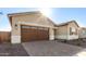 Two-car garage with brick paver driveway at 16399 W Avenida Del Sol --, Surprise, AZ 85387