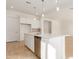 Island kitchen with white cabinets and stainless steel dishwasher at 16399 W Avenida Del Sol --, Surprise, AZ 85387