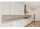 White kitchen with long countertop and stainless steel appliances at 16399 W Avenida Del Sol --, Surprise, AZ 85387