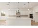 Modern kitchen with white cabinets and quartz countertops at 16399 W Avenida Del Sol --, Surprise, AZ 85387