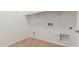 Laundry room with wood-look flooring and shelving at 16399 W Avenida Del Sol --, Surprise, AZ 85387