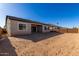 Backyard of a home with a covered patio and dirt landscaping at 21726 E Lords Way, Queen Creek, AZ 85142