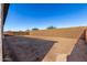 Spacious backyard enclosed by a privacy wall and open to landscaping possibilities at 21726 E Lords Way, Queen Creek, AZ 85142