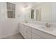 Clean and bright bathroom featuring dual vanities, modern fixtures, and white cabinetry at 21726 E Lords Way, Queen Creek, AZ 85142