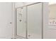 Walk-in shower with white tile surround and glass door at 21726 E Lords Way, Queen Creek, AZ 85142