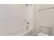 Simple, pristine bathroom with shower/tub combo, white toilet, and neutral tile flooring at 21726 E Lords Way, Queen Creek, AZ 85142