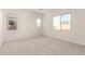 Empty bedroom with neutral carpet and multiple windows at 21726 E Lords Way, Queen Creek, AZ 85142