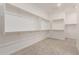 Large walk-in closet with built-in shelving and plenty of storage space at 21726 E Lords Way, Queen Creek, AZ 85142