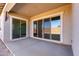 Covered back patio with sliding glass doors leading into the home at 21726 E Lords Way, Queen Creek, AZ 85142