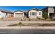 Charming single-story home with a two-car garage and landscaped front yard at 21726 E Lords Way, Queen Creek, AZ 85142