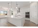 Spacious kitchen with white cabinets, a quartz countertop island, and stainless steel appliances at 21726 E Lords Way, Queen Creek, AZ 85142