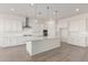 Modern kitchen featuring white shaker cabinets, stainless steel appliances, and a large island at 21726 E Lords Way, Queen Creek, AZ 85142