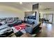 Open living room and kitchen with sectional sofa and large TV at 11322 W Diana Ave, Peoria, AZ 85345