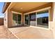 Covered back patio with sliding glass doors leading to the backyard at 21673 E Roundup Way, Queen Creek, AZ 85142