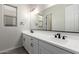 Modern bathroom with double sinks, white vanity, and black fixtures at 21673 E Roundup Way, Queen Creek, AZ 85142