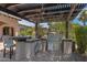 Covered outdoor kitchen with grill and bar seating at 4327 E Capricorn Pl, Chandler, AZ 85249