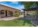 Outdoor kitchen and pergola with artificial turf at 4327 E Capricorn Pl, Chandler, AZ 85249