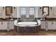 Spa-like bathroom with double vanities and a large soaking tub, creating a relaxing retreat at 4327 E Capricorn Pl, Chandler, AZ 85249