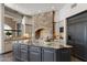 Spacious kitchen boasting stone fireplace and granite island at 4327 E Capricorn Pl, Chandler, AZ 85249
