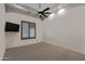 Simple bedroom with large window and wall-mounted television at 4327 E Capricorn Pl, Chandler, AZ 85249