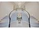 Grand entryway with double staircase and chandelier at 3852 E Expedition Way, Phoenix, AZ 85050