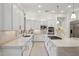 Modern kitchen with white cabinets, marble countertops, and stainless steel appliances at 3852 E Expedition Way, Phoenix, AZ 85050